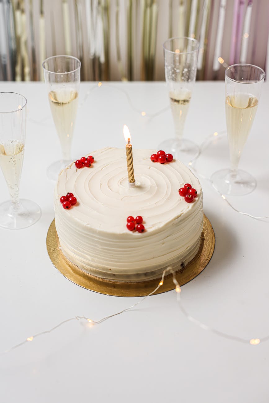 a close up shot of a cake with a candle on top