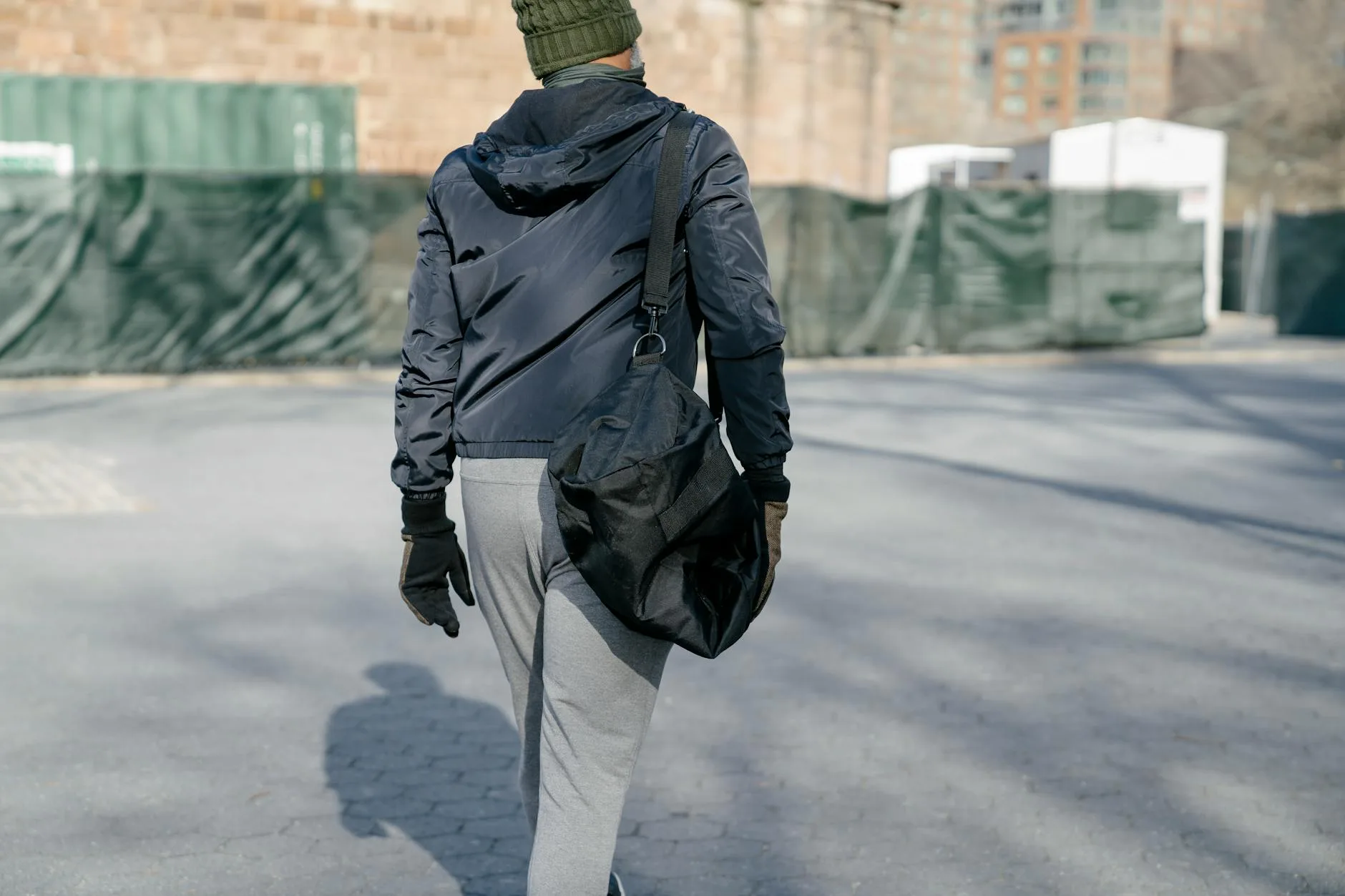 man with bag on autumn street