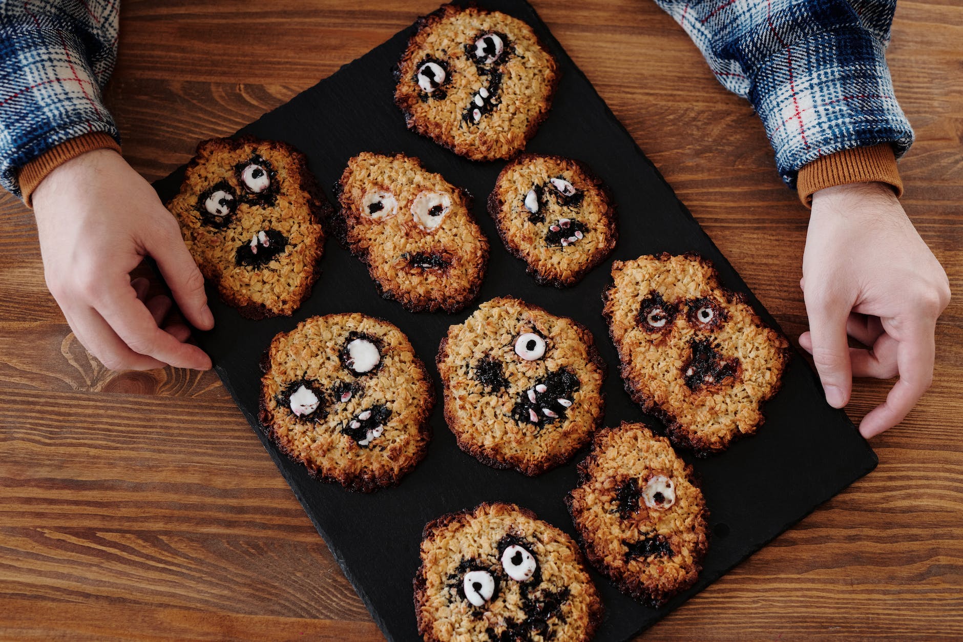 brown cookies decorated with various facial expressions